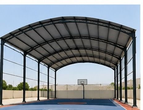 Steel arched sports playing shed over a court, fabricated by MRFT in Oman
